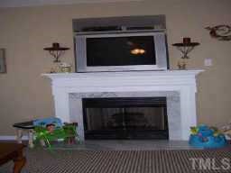 127 Saddle Ridge Drive Willow Spring, NC 27592 - Photo 4 of 10 a living room with a fireplace