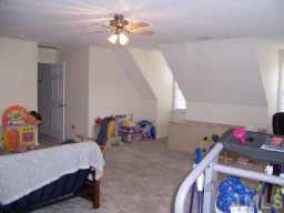 127 Saddle Ridge Drive Willow Spring, NC 27592 - Photo 8 of 10 a bedroom with a bed and a chandelier