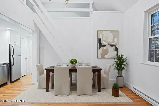 a view of a dining room with furniture and a potted plant