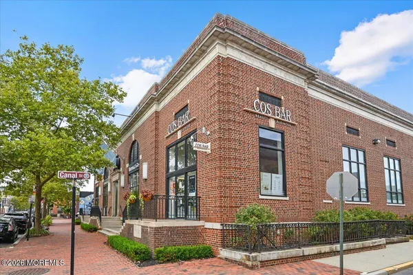 a view of a brick building next to a road