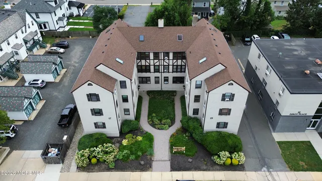 an aerial view of a house a yard and a garage