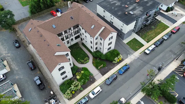 an aerial view of residential houses with outdoor space and street view
