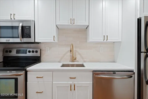 a kitchen with cabinets and appliances