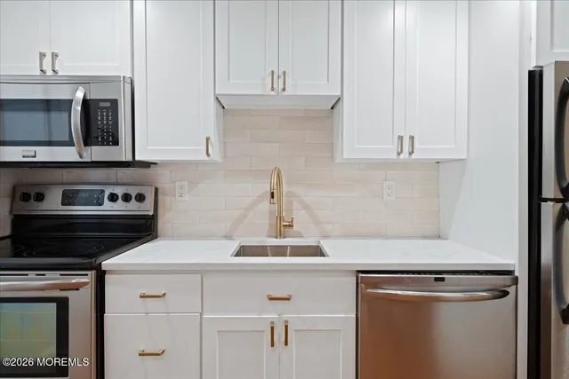 a kitchen with cabinets and appliances