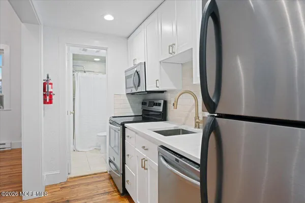 a kitchen with stainless steel appliances a refrigerator and a stove