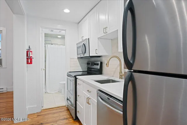 a kitchen with stainless steel appliances a refrigerator and a stove