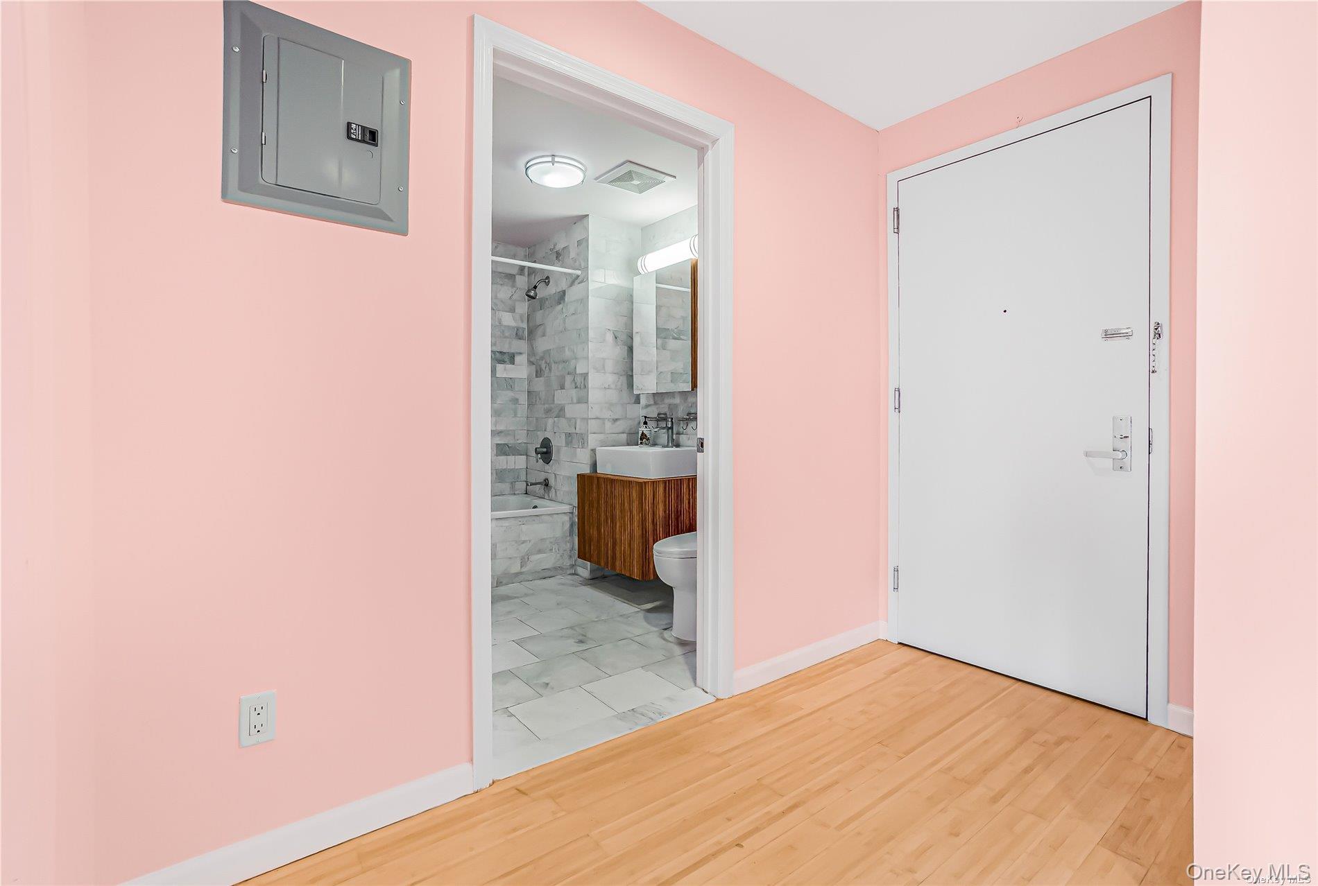 112-02 Northern Boulevard, Unit PHC Queens, NY 11368 - Photo 21 of 24 hallway with wooden floor and a bathroom