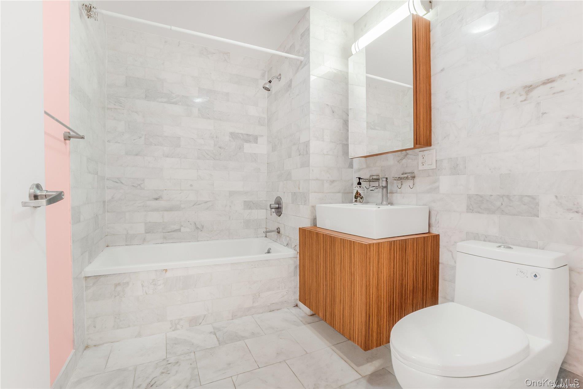 112-02 Northern Boulevard, Unit PHC Queens, NY 11368 - Photo 22 of 24 a bathroom with a sink a toilet and shower