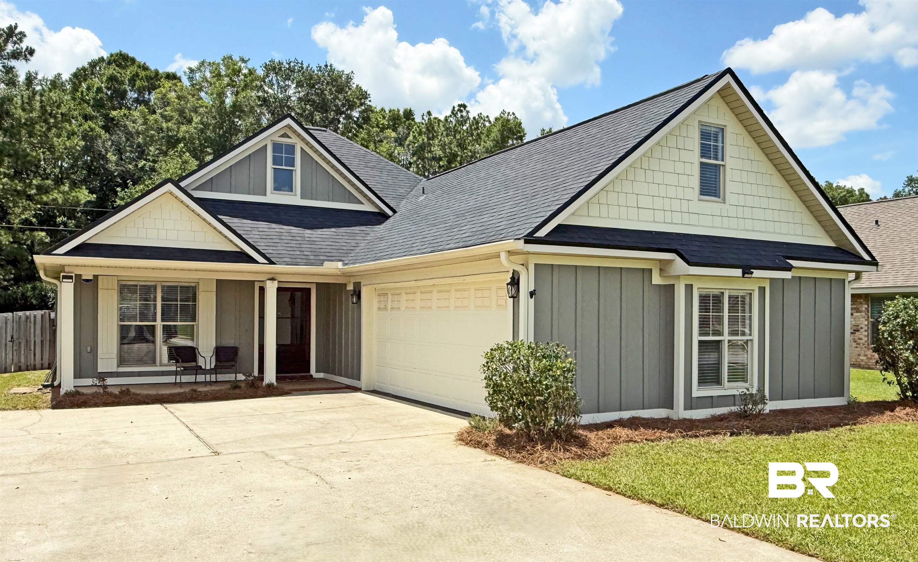 22023 Garland Loop Silverhill, AL 36576 - Photo 1 of 33 View of front of house featuring a garage, covered porch, board and batten siding, concrete driveway, and roof with shingles