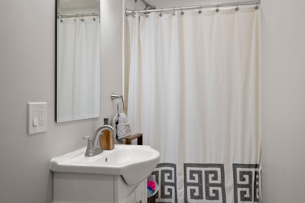 10 Brookdale Road Natick, MA 01760 - Photo 14 of 19 a bathroom with a sink a toilet and a mirror