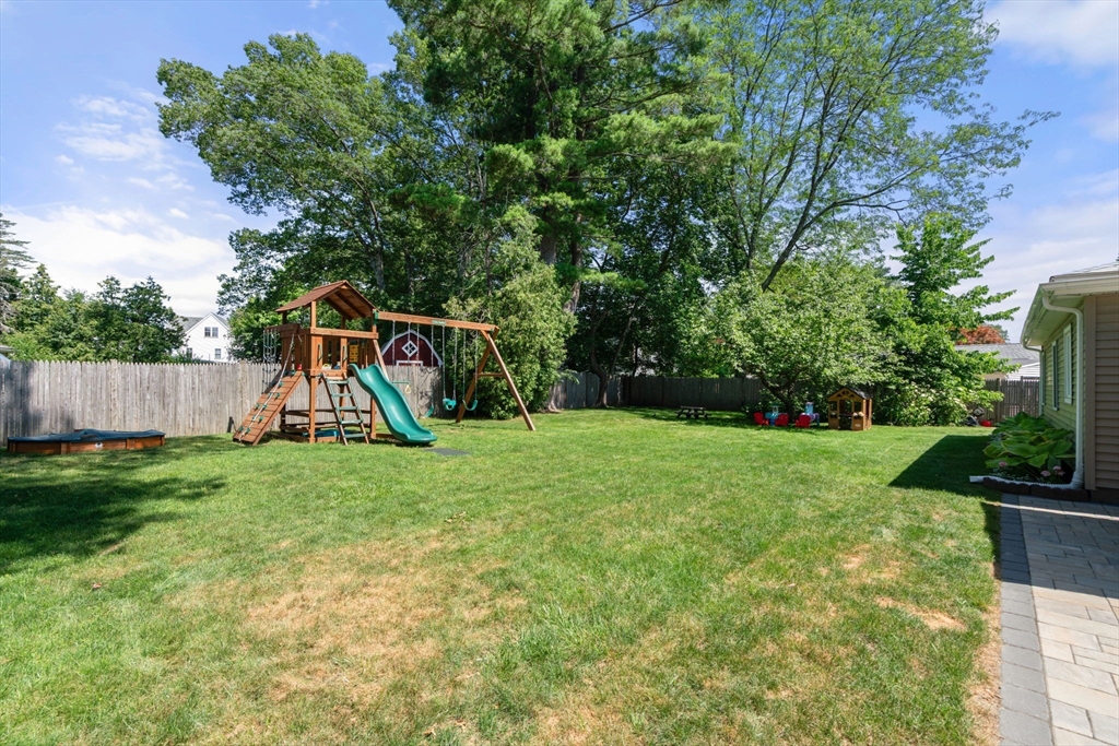 10 Brookdale Road Natick, MA 01760 - Photo 17 of 19 a view of a backyard with a slide trees and wooden fence