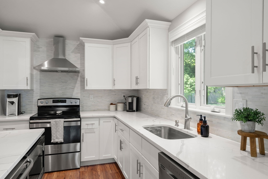 10 Brookdale Road Natick, MA 01760 - Photo 6 of 19 a kitchen with a sink a stove and cabinets
