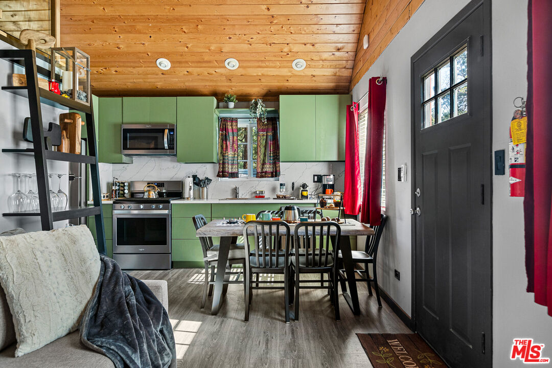 306 Victoria Lane Sugarloaf, CA 92386 - Photo 5 of 37 a kitchen with sink a microwave and cabinets