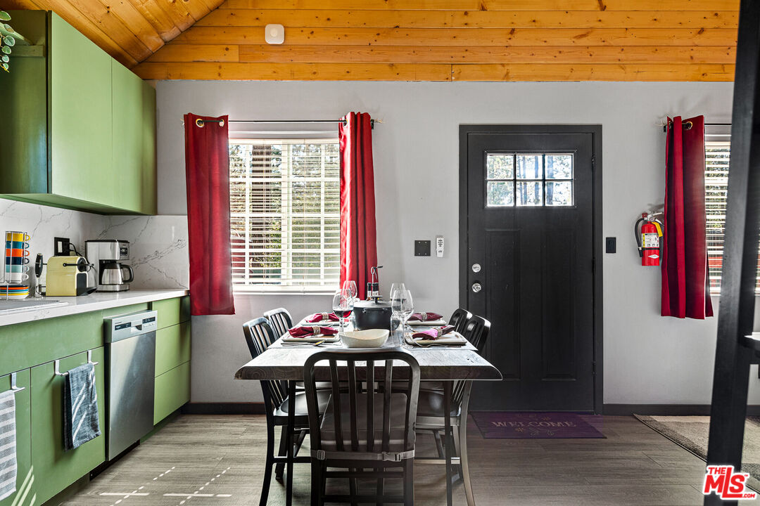 306 Victoria Lane Sugarloaf, CA 92386 - Photo 6 of 37 a dining room with a wooden table and chairs