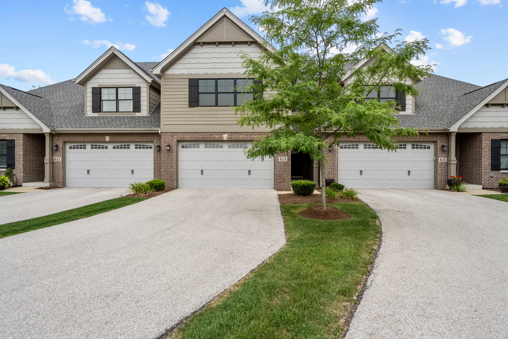 613 Bourbon Lane Naperville, IL 60565 - Photo 2 of 36 a front view of a house with a yard and garage