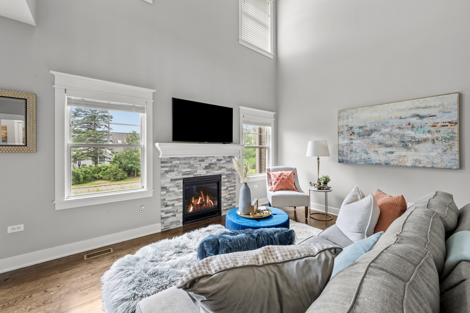 613 Bourbon Lane Naperville, IL 60565 - Photo 5 of 36 a living room with furniture a flat screen tv and a fireplace