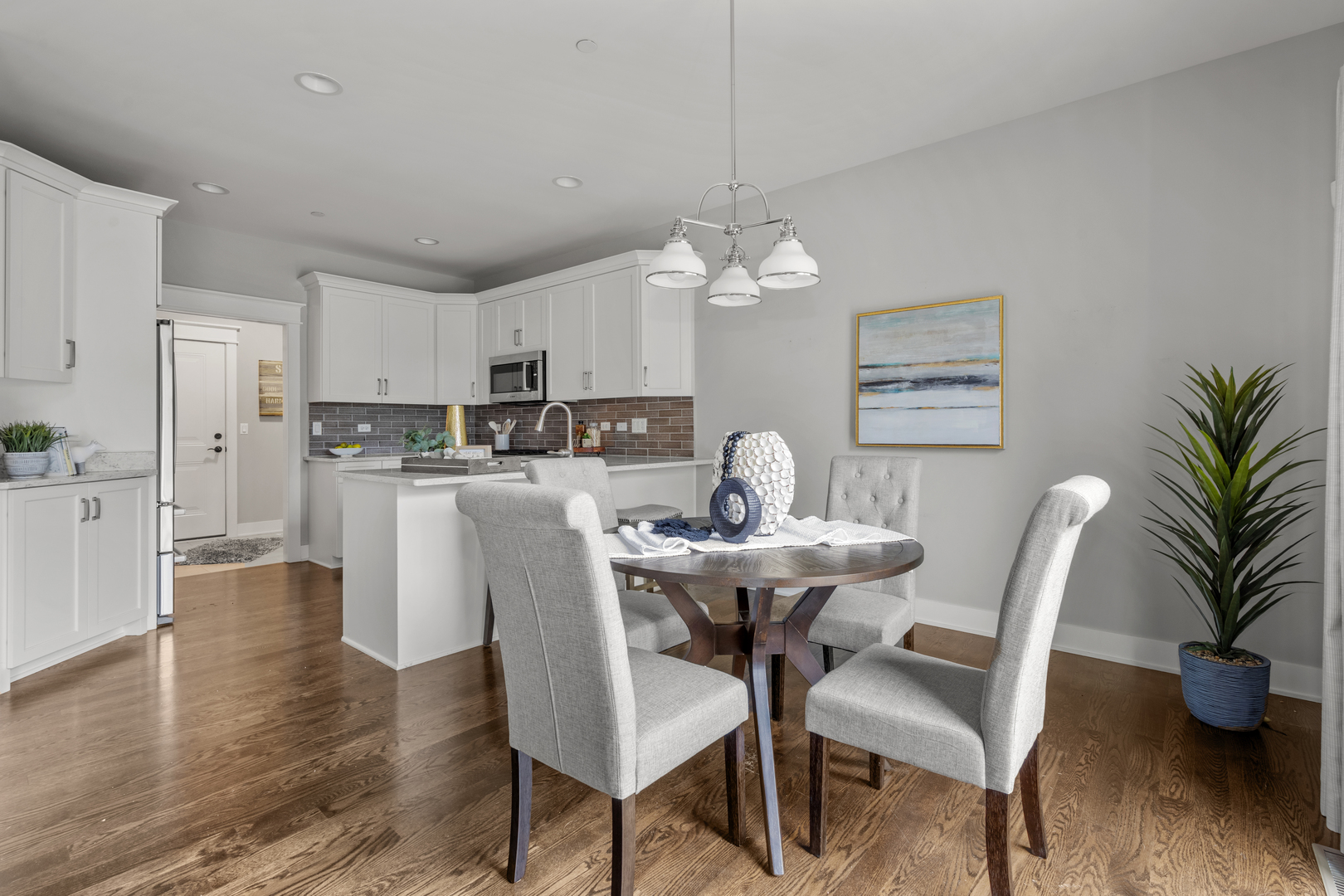 613 Bourbon Lane Naperville, IL 60565 - Photo 6 of 36 a view of a dining room with furniture wooden floor and chandelier