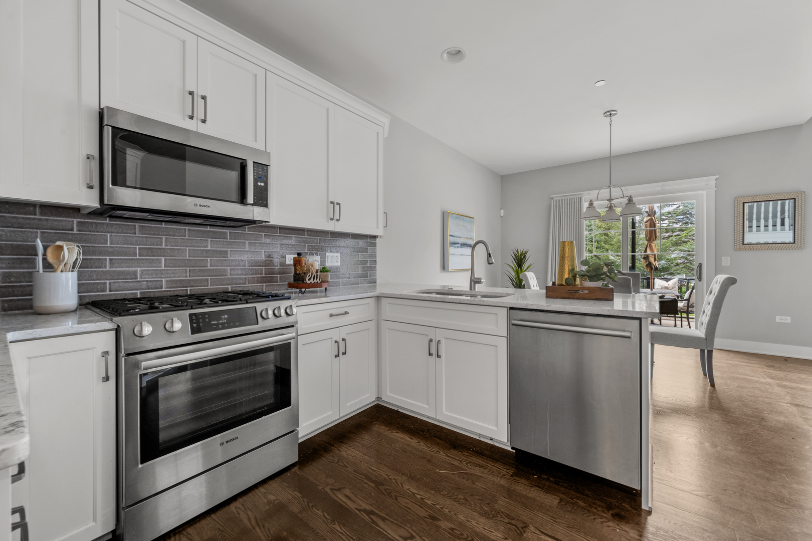 613 Bourbon Lane Naperville, IL 60565 - Photo 8 of 36 a kitchen with stainless steel appliances granite countertop a stove a sink and a microwave