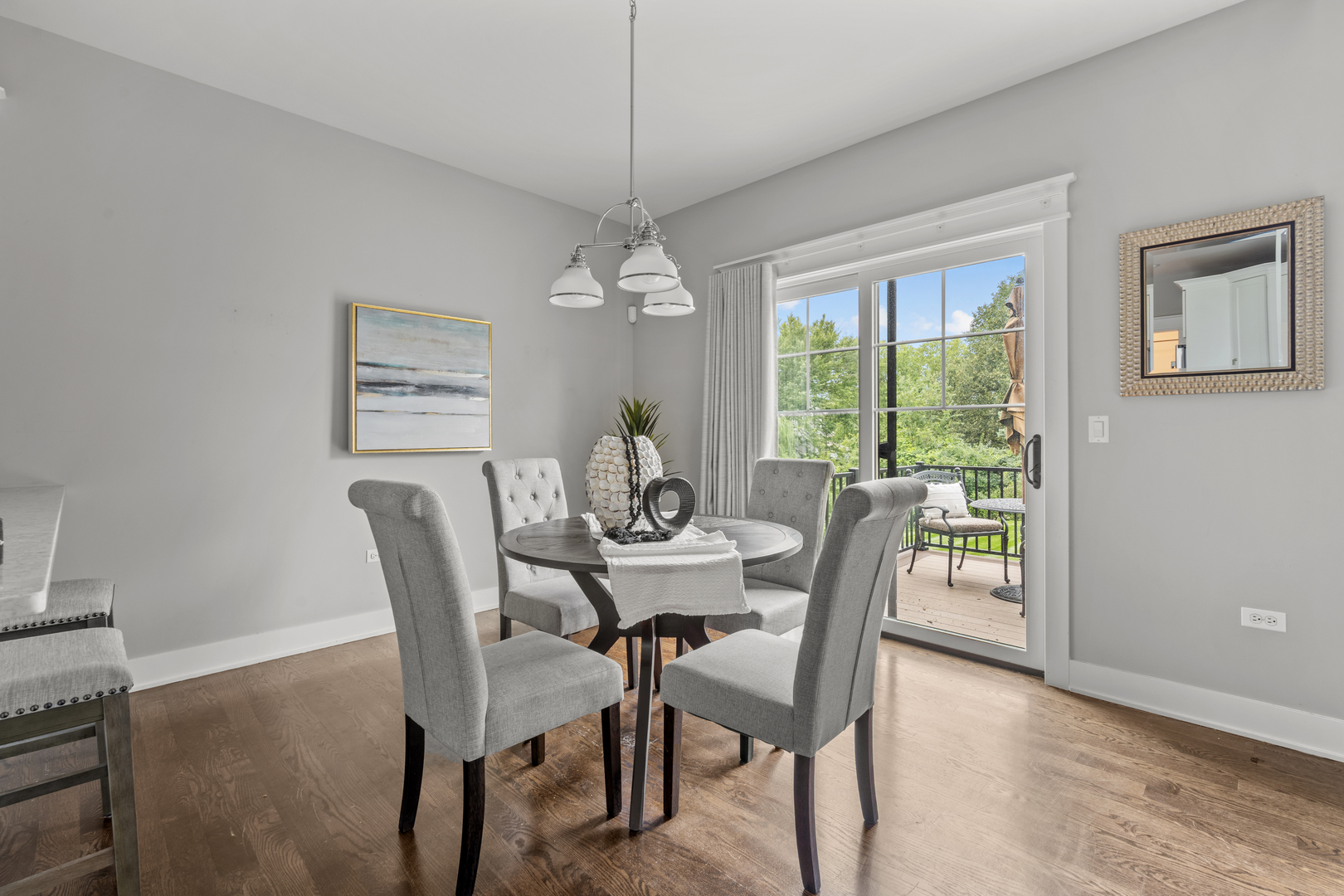 613 Bourbon Lane Naperville, IL 60565 - Photo 9 of 36 a dining room with furniture a chandelier and wooden floor