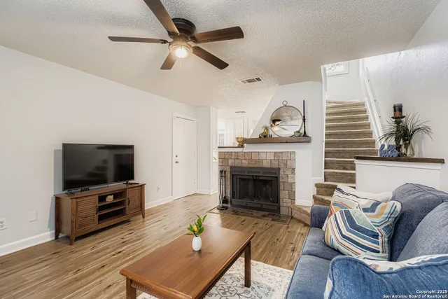 a living room with furniture a fireplace and a flat screen tv