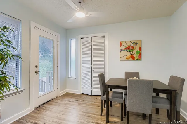 a view of a dining room with furniture a chandelier and wooden floor