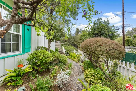 a view of a pathway with a wooden fence