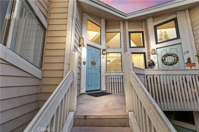 a view of a porch with wooden floor and iron stairs