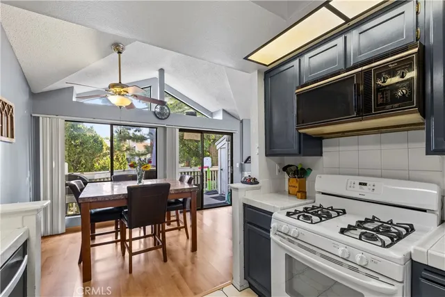 a kitchen with a stove a sink and a dining table