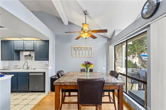 a view of a dining room with furniture a rug and a chandelier