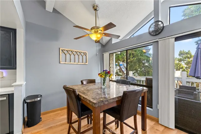 a view of a dining room with furniture a chandelier and wooden floor