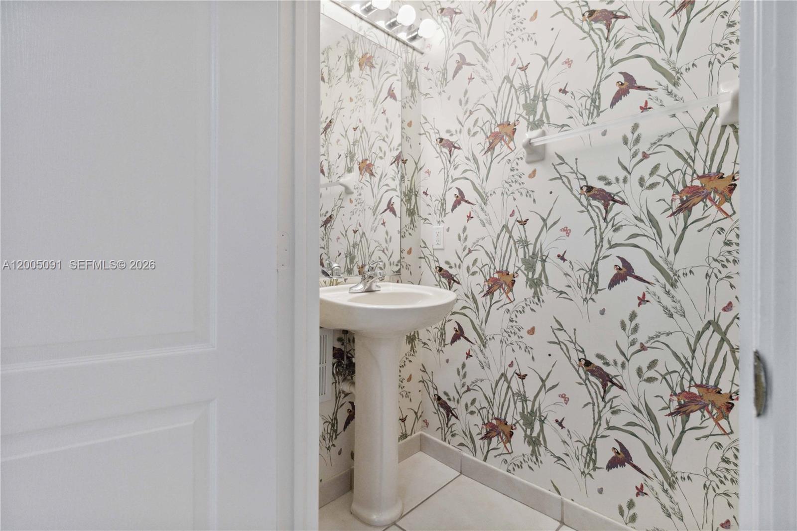 3079 Southwest 129th Way, Unit 159 Miramar, FL 33027 - Photo 16 of 44 a bathroom with a sink and a mirror