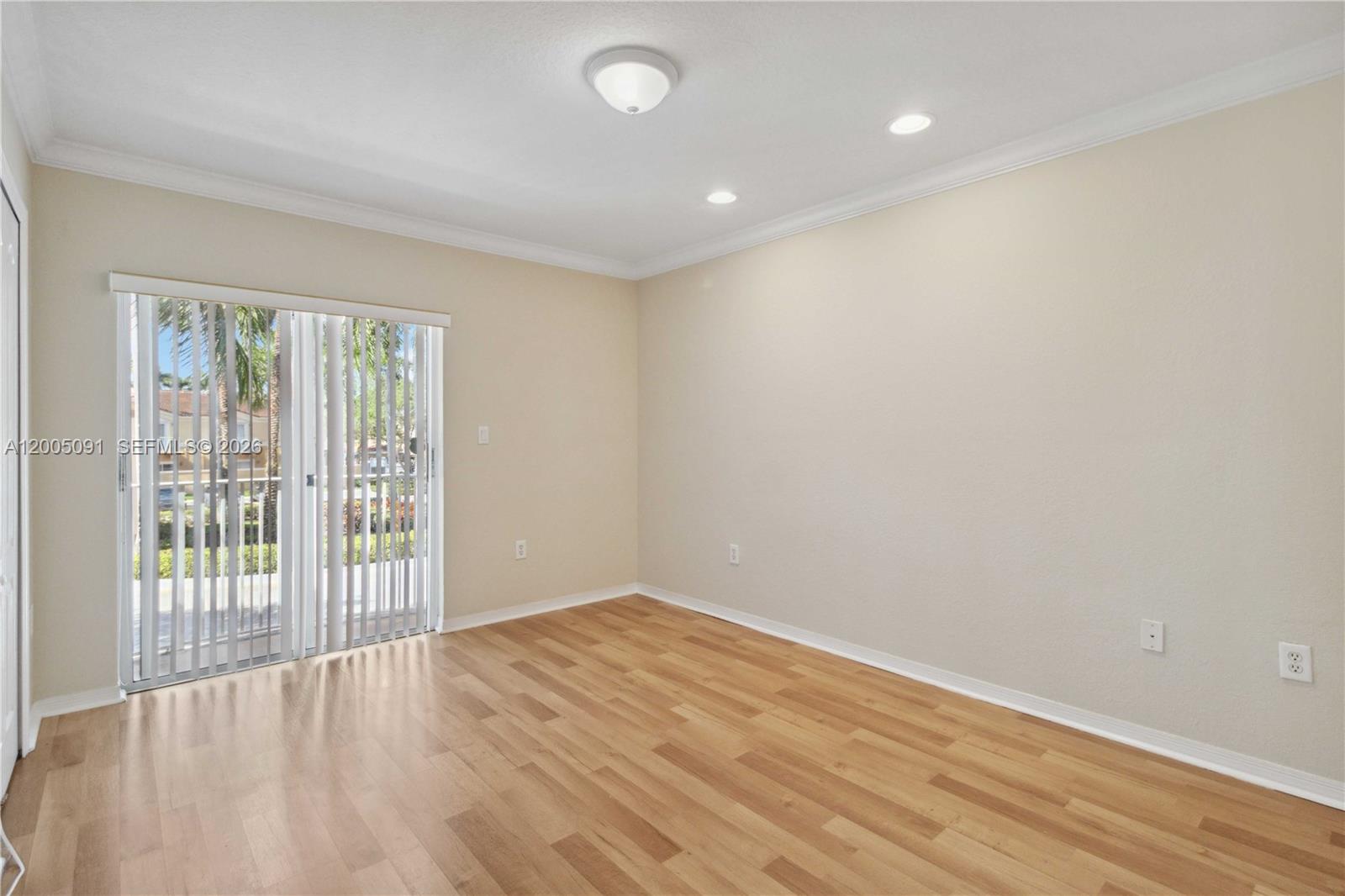 3079 Southwest 129th Way, Unit 159 Miramar, FL 33027 - Photo 23 of 44 wooden floor in an empty room with a window