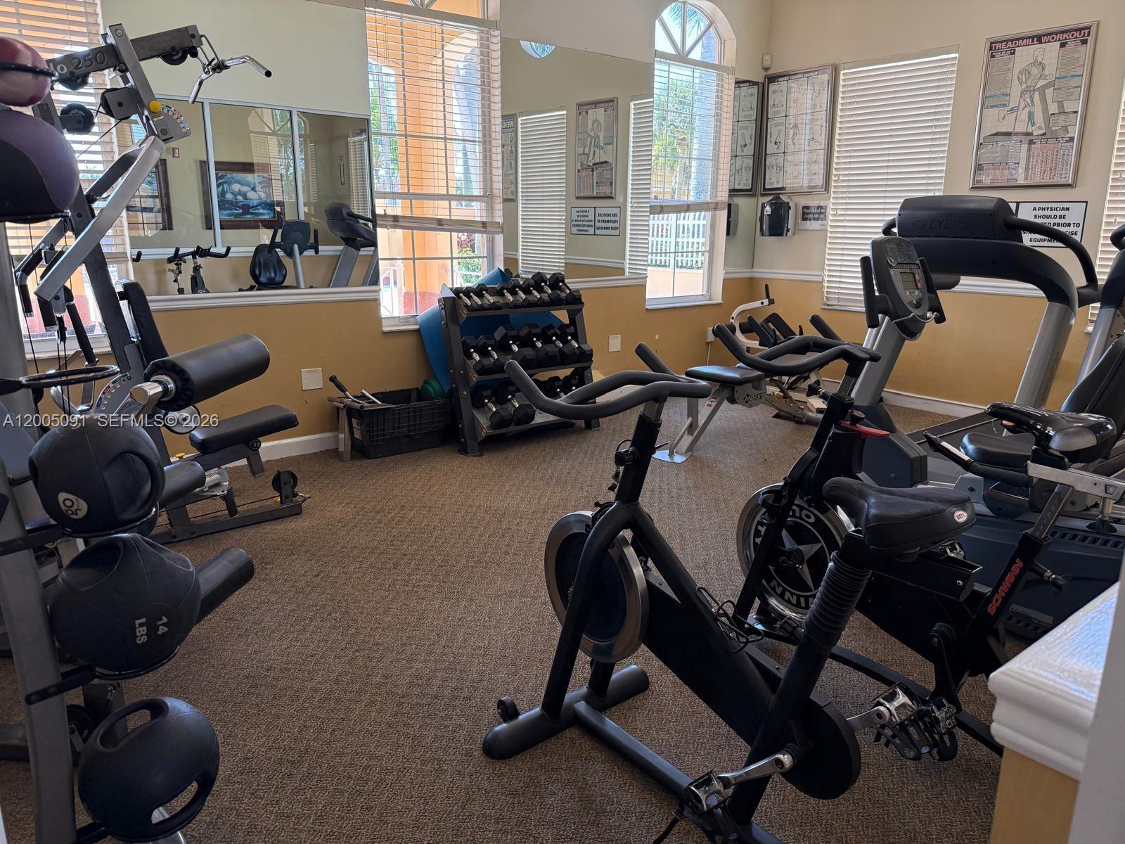 3079 Southwest 129th Way, Unit 159 Miramar, FL 33027 - Photo 40 of 44 a view of a workspace with gym equipment