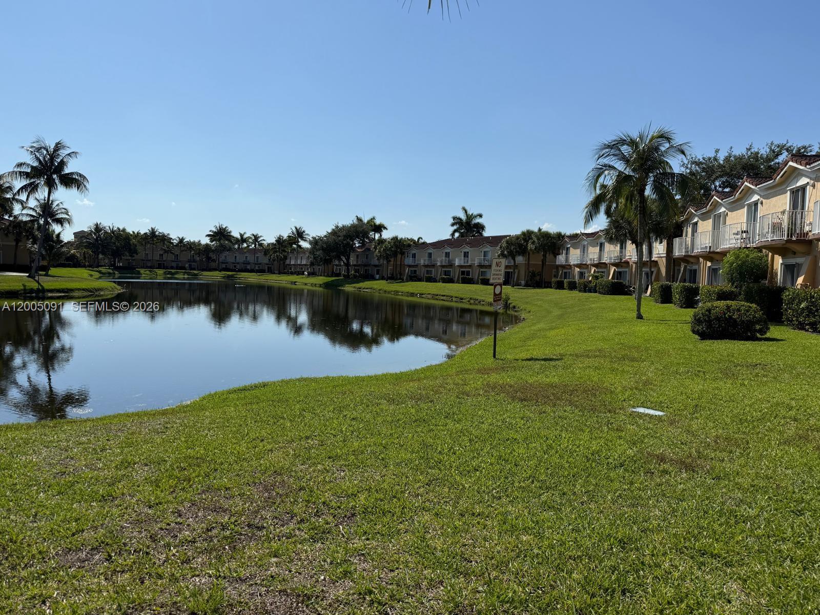 3079 Southwest 129th Way, Unit 159 Miramar, FL 33027 - Photo 43 of 44 a view of a lake with houses in the background