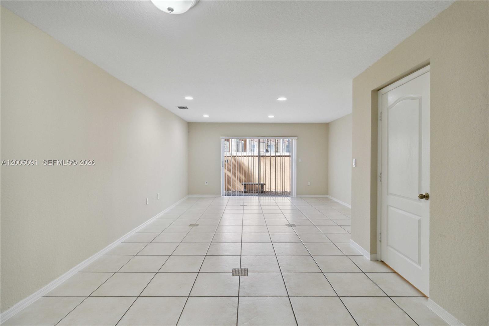 3079 Southwest 129th Way, Unit 159 Miramar, FL 33027 - Photo 8 of 44 a view of an empty room and window