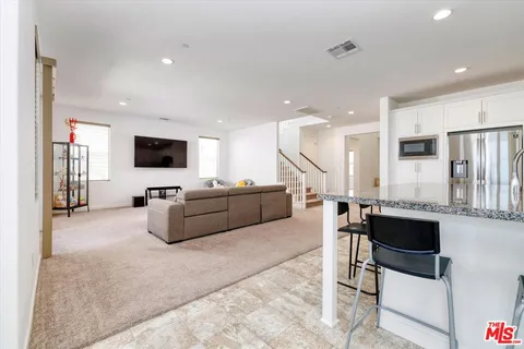 a bedroom with furniture and a flat screen tv