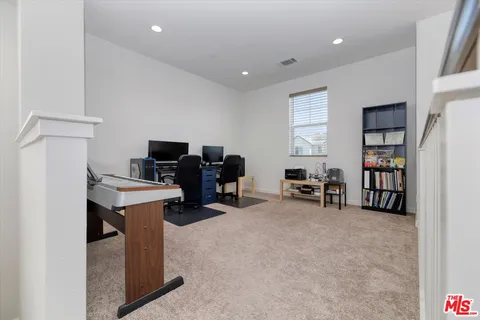 a bedroom with a bed and a desk