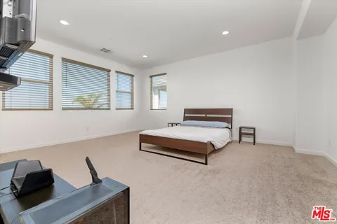 a bedroom with bed and tv