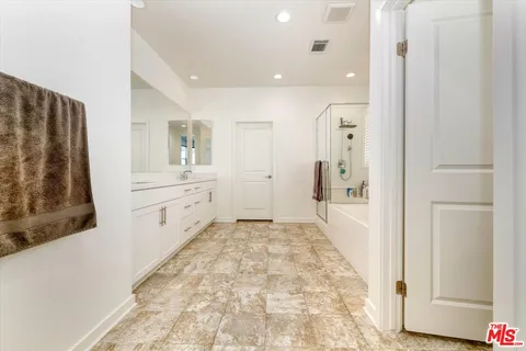 a bathroom with a sink double vanity and a mirror
