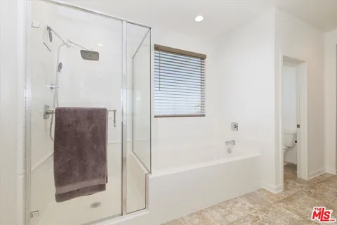 a bathroom with a toilet and a bathtub