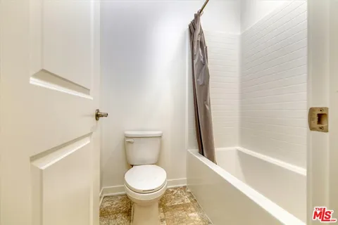 a spacious bedroom with a bed and a window