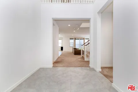 a bedroom with a bed and a potted plant