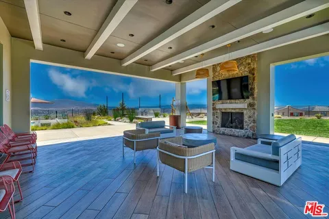 a view of a chairs and table in the patio