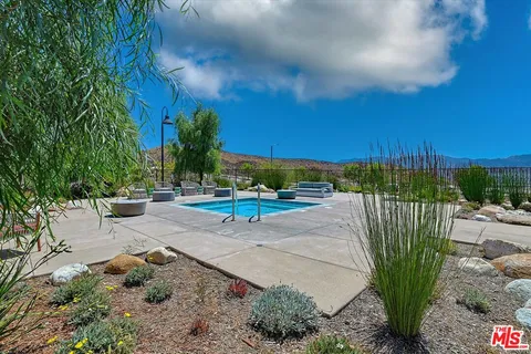 a view of a house with a yard patio and fire pit