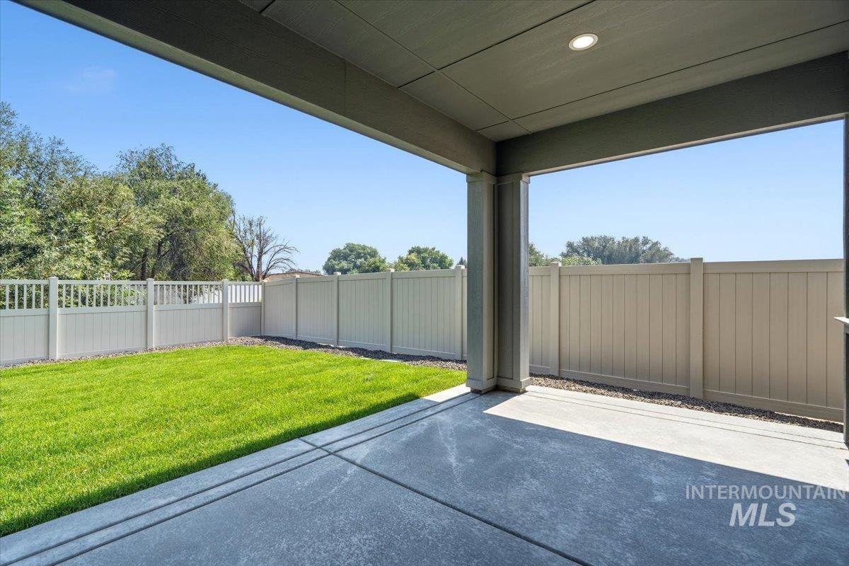 4317 Tropic Way Caldwell, ID 83607 - Photo 39 of 47 Covered patio with recessed lighting, concrete flooring, and a fully fenced yard with a manicured lawn