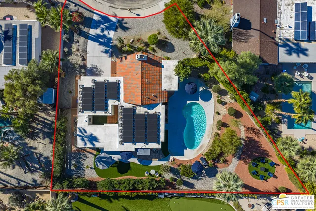 an aerial view of multi story residential apartment building with yard and outdoor seating