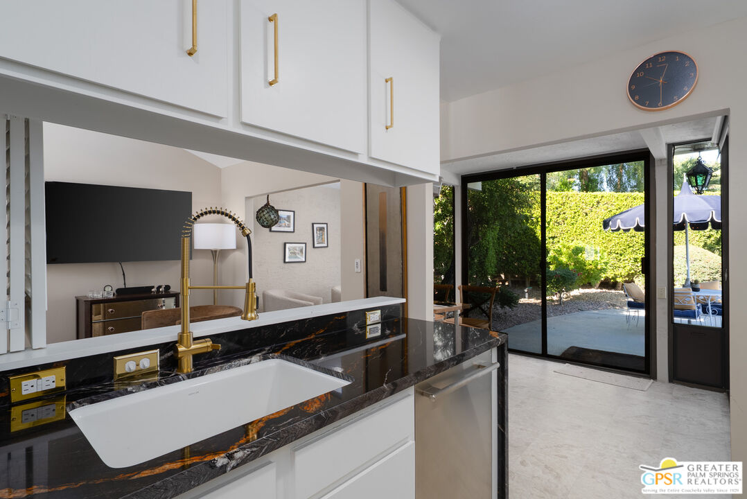 566 North Sunset Way Palm Springs, CA 92262 - Photo 11 of 39 a room with gym equipment and a large window