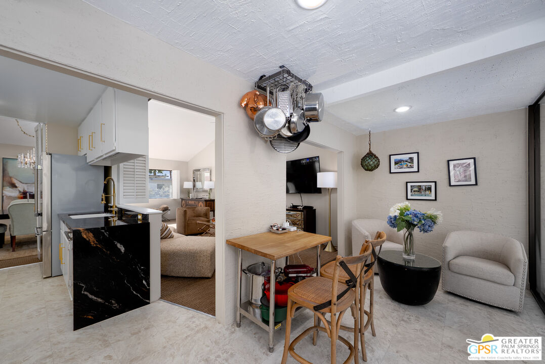566 North Sunset Way Palm Springs, CA 92262 - Photo 12 of 39 a living room with furniture and a kitchen