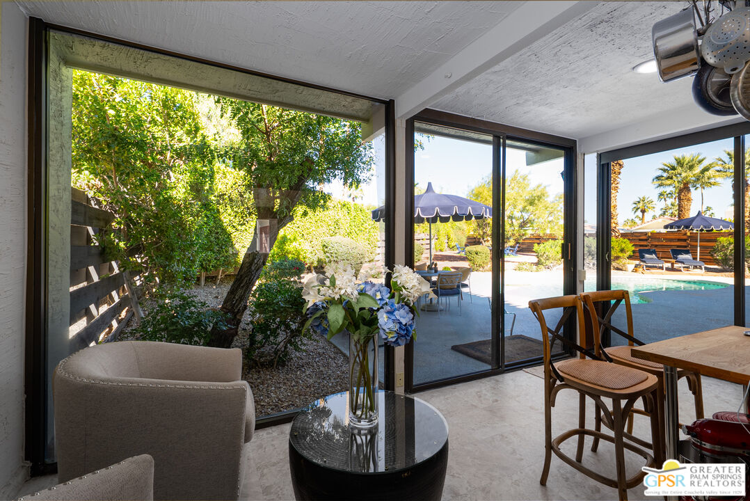566 North Sunset Way Palm Springs, CA 92262 - Photo 13 of 39 a living room with furniture and a large window