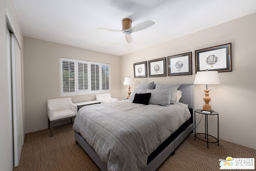 566 North Sunset Way Palm Springs, CA 92262 - Photo 17 of 39 a bedroom with a bed and a large window